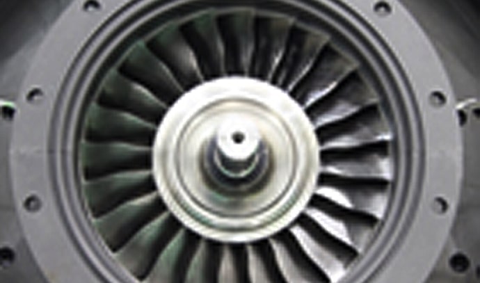 제트 엔진 터빈 팬의 근접 사진, 블레이드가 방사형으로 배열되어 있음